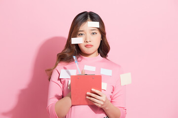 Funny portrait of busy female employee with many memo paper attached on body