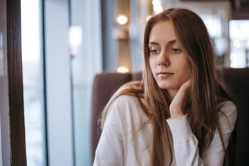 unhappy lonely beauty woman sitting on couch in bar