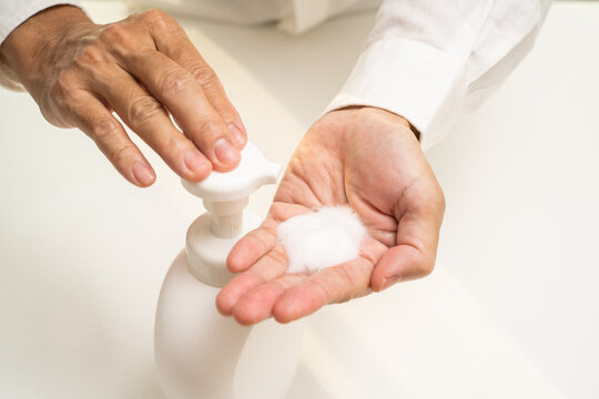 Hand sanitizer soap foam clean hands hygiene prevention of corona virus outbreak. Man using bottle of antibacterial sanitiser soap. covid-19