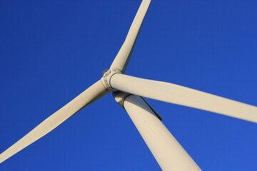 Wind farm turbines that produce electricity energy. Windmill Wind power technology productions Wind turbines standing in green field - stock footage