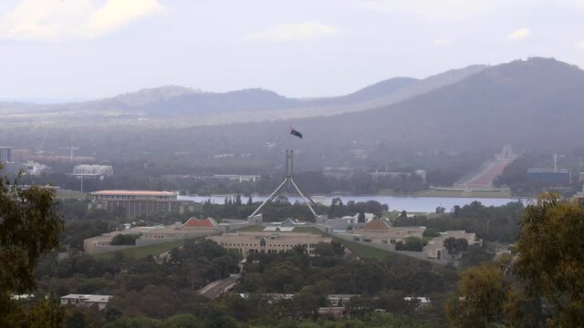 The capitol hill with federal parliament under national australian flag &ndash; ACT.

