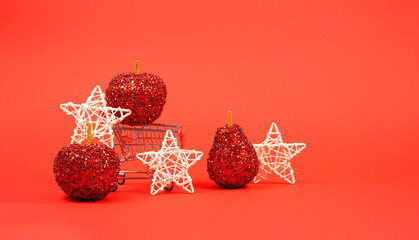 Shopping cart with Christmas decorations on a red background