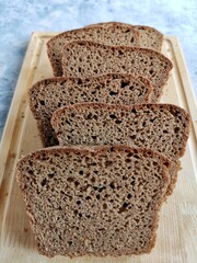 homemade rye bread on sourdough sliced on a wooden board 