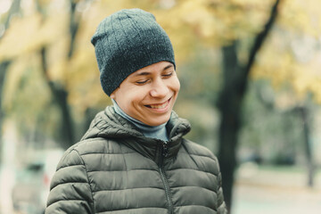 happy teen boy posing outdoor, autumn season, city street
