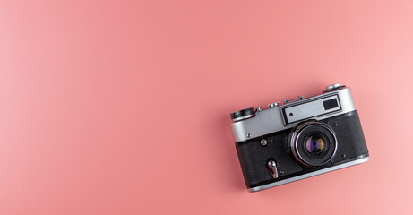Old camera on a pink background