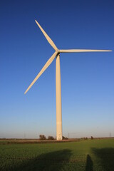 Fototapeta na wymiar Wind farm turbines that produce electricity energy. Windmill Wind power technology productions Wind turbines standing in green field - stock footage