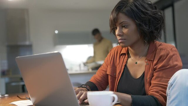 Portrait of woman entrepreneur working from home on laptop 