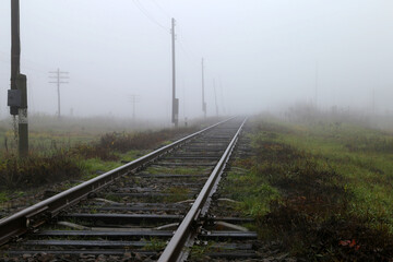Fototapeta na wymiar empty railroad in fog