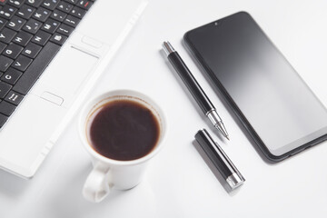 Obraz na płótnie Canvas Office desk. Smartphone, keyboard, coffee, pen.