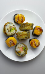 sushi rolls with salmon on a white plate