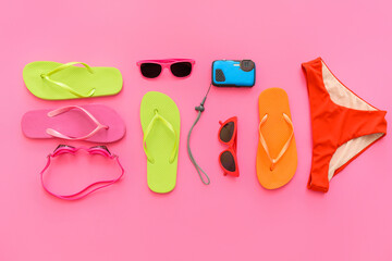 Set of beach accessories with flip-flops on color background. Concept of family vacation
