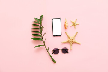 Set of mobile phone, sunglasses and seashells on color background