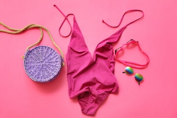 Set of beach accessories with female swimsuit on color background