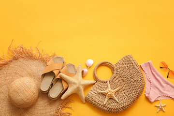Wicker beach accessories on color background