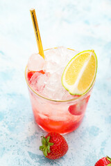 Glass of fresh strawberry lemonade on light table