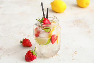 Jar of fresh strawberry lemonade on light table