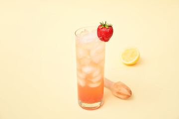 Glass of fresh strawberry lemonade on color background