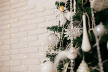 Christmas tree decoration: Christmas glass toys, flickering garlands. concept: an example of the...