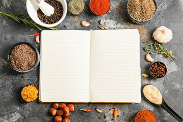 Notebook for recipes and spices on grey table