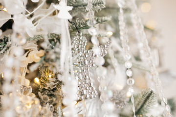 Christmas tree decoration: Christmas glass toys, flickering garlands. concept: an example of the...