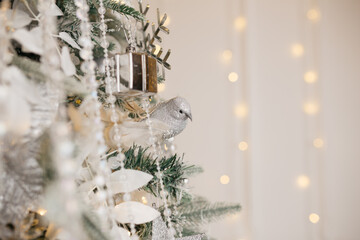 Christmas tree decoration: Christmas glass toys, flickering garlands. concept: an example of the...