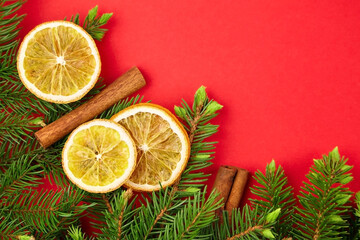 Fototapeta na wymiar Dry orange slices with christmas tree branches and cinnamon sticks