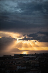sunset where you see the clouds and the sun's rays through the clouds