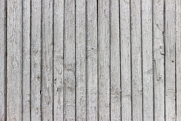 The surface of old wooden boards with peeling and weathered paint.