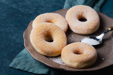 Doughnuts donut with sugar on wooden table.