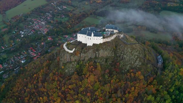 Fuzer, Hungary - 4K drone flying around the Castle of Fuzer at the Zemplen Mountains on an autumn morning with fog around the castle