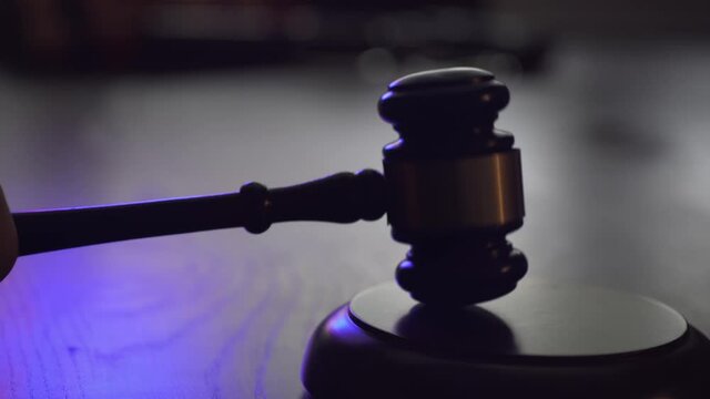Judge is knocking with gavel. Blinking police lights around. Law and justice concept.