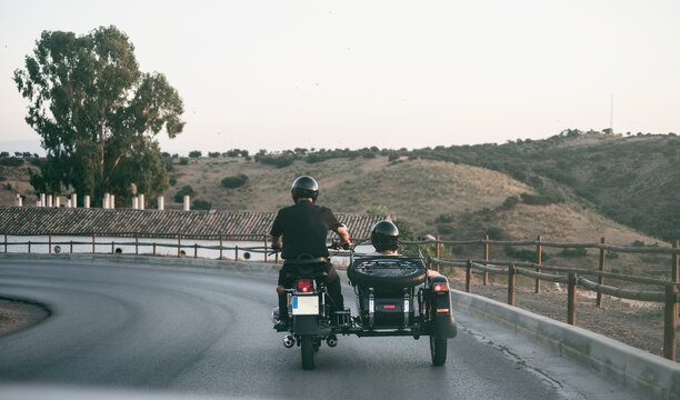 Senior couple riding on sidecar bike in road. Jaen, Spain