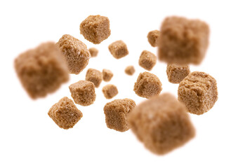 Brown cane sugar levitates on a white background