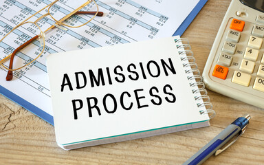 ADMISSION PROCESS is written on a notepad on an office desk