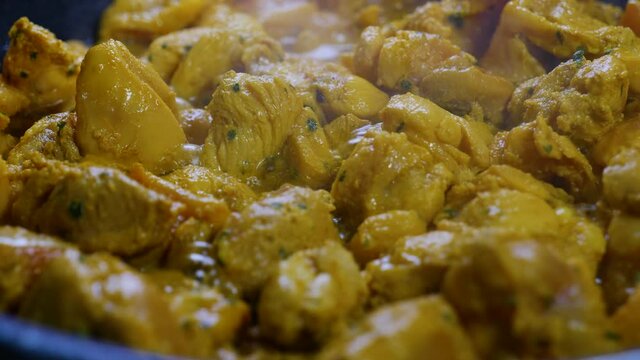 Scene in the kitchen with hot pan and making Moorish chicken skewers in Spainol style, nutritious and delicious.