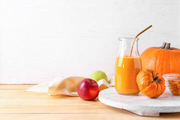 Bottle of tasty pumpkin smoothie on table