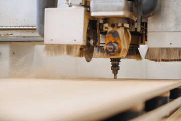 Closeup shot of an industrial working plywood carving machine