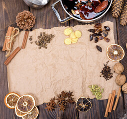 ingredients for making mulled wine on a wooden table and a piece of brown paper