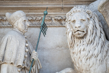 Winged lion with a Bible and a priest at Basilica San Marco in Venice, Italy, summer time, details, closeup