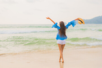 Portrait beautiful young asian woman relax leisure smile around beach sea ocean