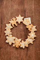 Gingerbread Christmas cookies viewed from above on a wooden background. Top view