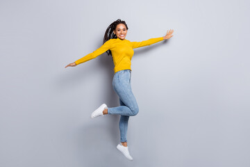 Fototapeta na wymiar Full body photo of young cheerful active afro girl happy positive smile jump up isolated over grey color background