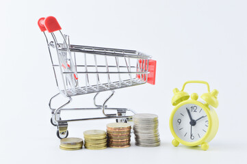 View of shopping cat, coins and clock isolated on a white background. Shopping concept.
