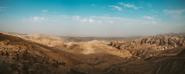 Fototapeta premium Panorama The mountain landscape, dried up from the wind and sun, has burned out all the green vegetation, and only hills and mountains, clear blue skies and sunny weather are good for traveling.