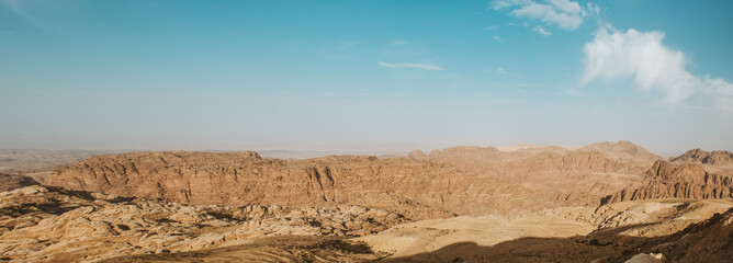 Panorama The mountain landscape, dried up from the wind and sun, has burned out all the green vegetation, and only hills and mountains, clear blue skies and sunny weather are good for traveling.