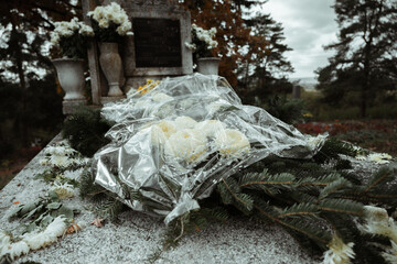 Grave in cemetery with flowers for concept of death and loss. All soul's day.
