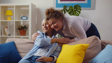 Young woman visiting her mother with cancer indoors