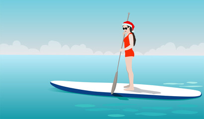 Young woman standing on sup board in Christmas costume