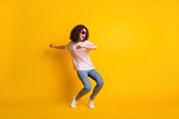 Fototapeta na wymiar Photo portrait full body view of girl dancing isolated on vivid yellow colored background