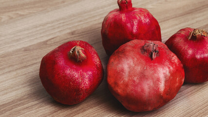 Fototapeta na wymiar several pomegranate fruits on a wooden background. healthy eating